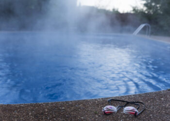 Swim goggles cast aside from an empty swimming pool